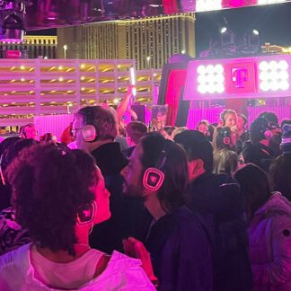 Audience wearing pink-glowing silent disco headphones at the T Mobile Zone at Formula 1 Las Vegas